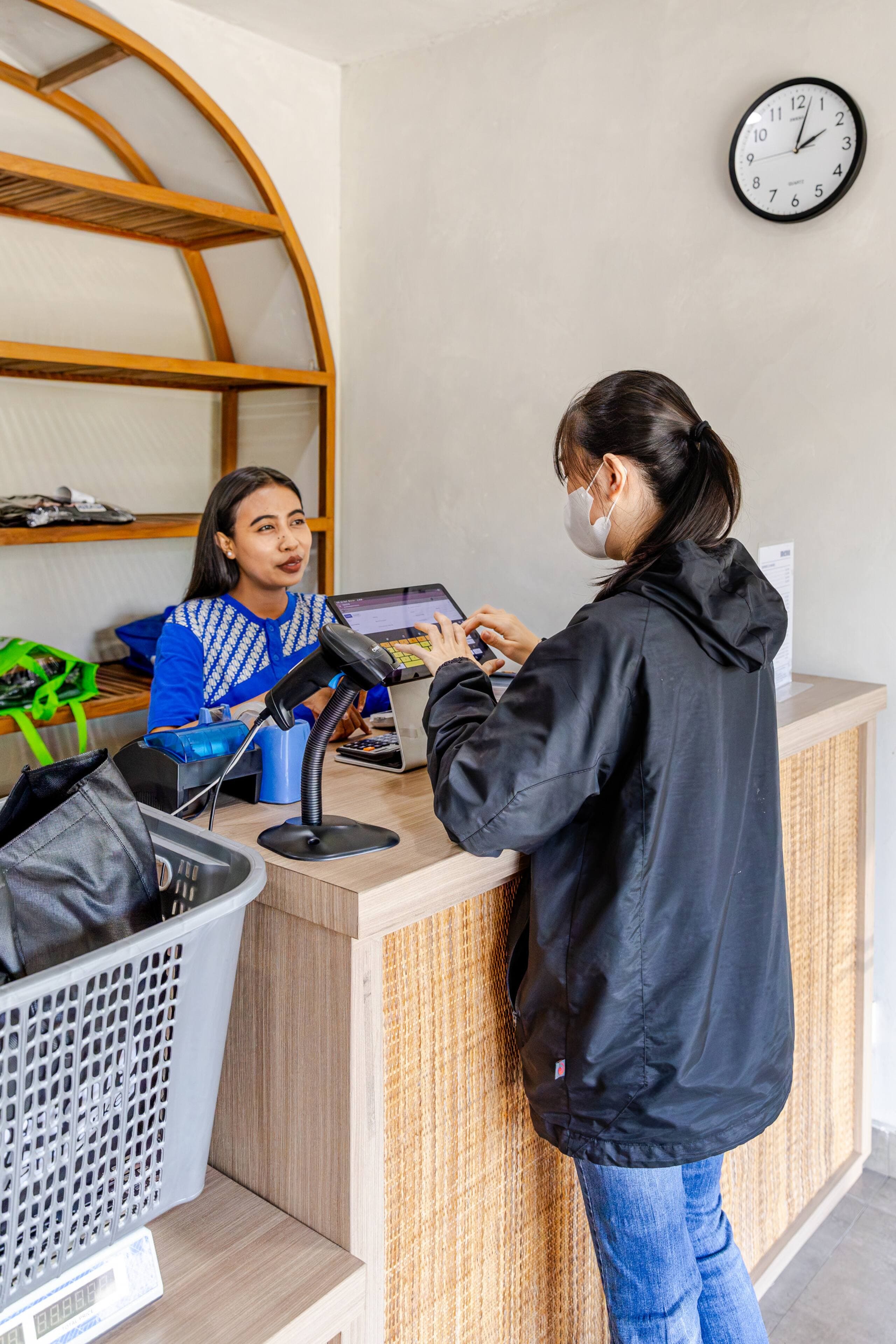 Easy Day Laundry team member at the counter helping a customer enter an order