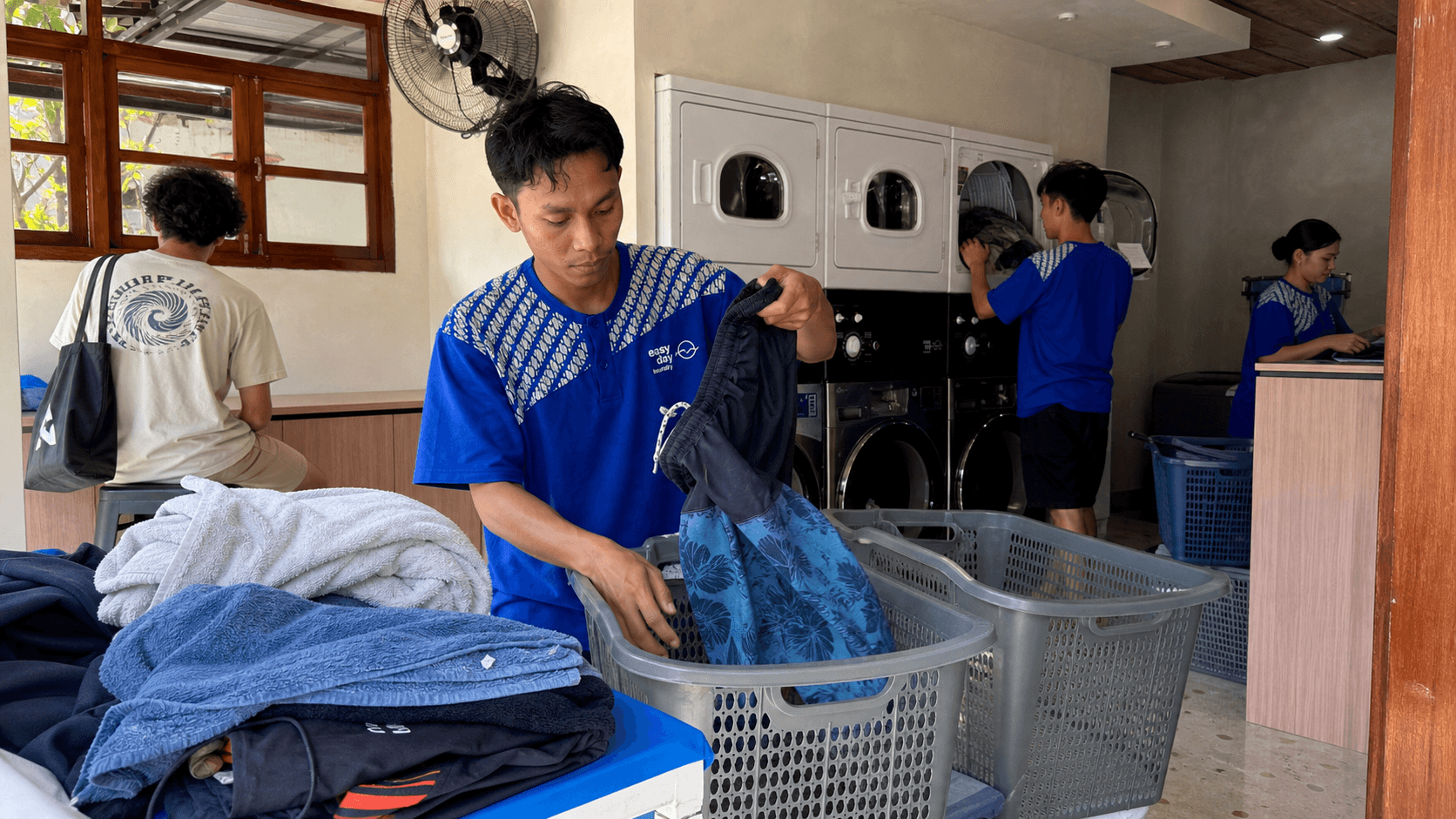 Clean folded clothes and surfwear for laundry service near Batu Bolong