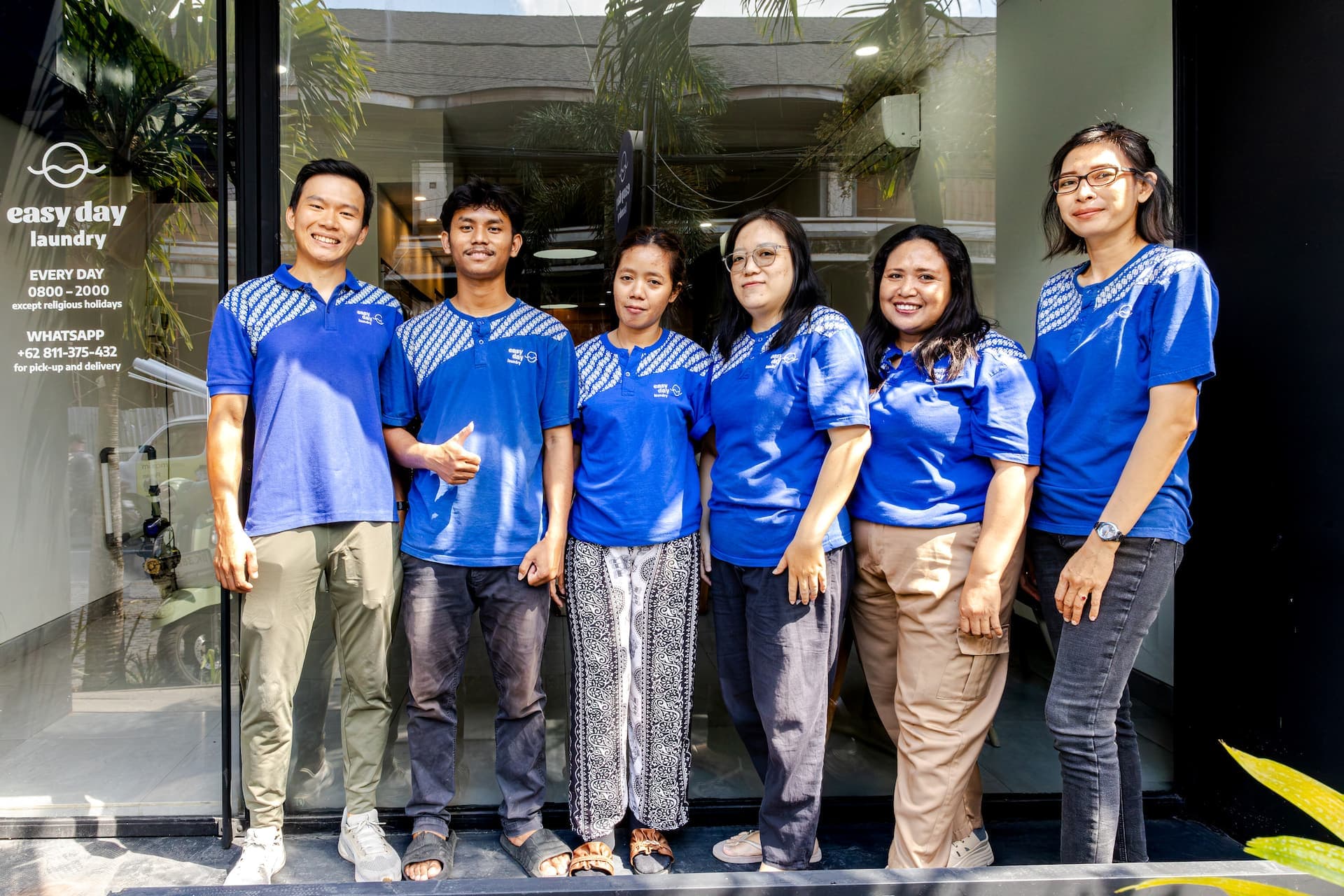 The Easy Day Laundry team in uniform outside the Canggu shop