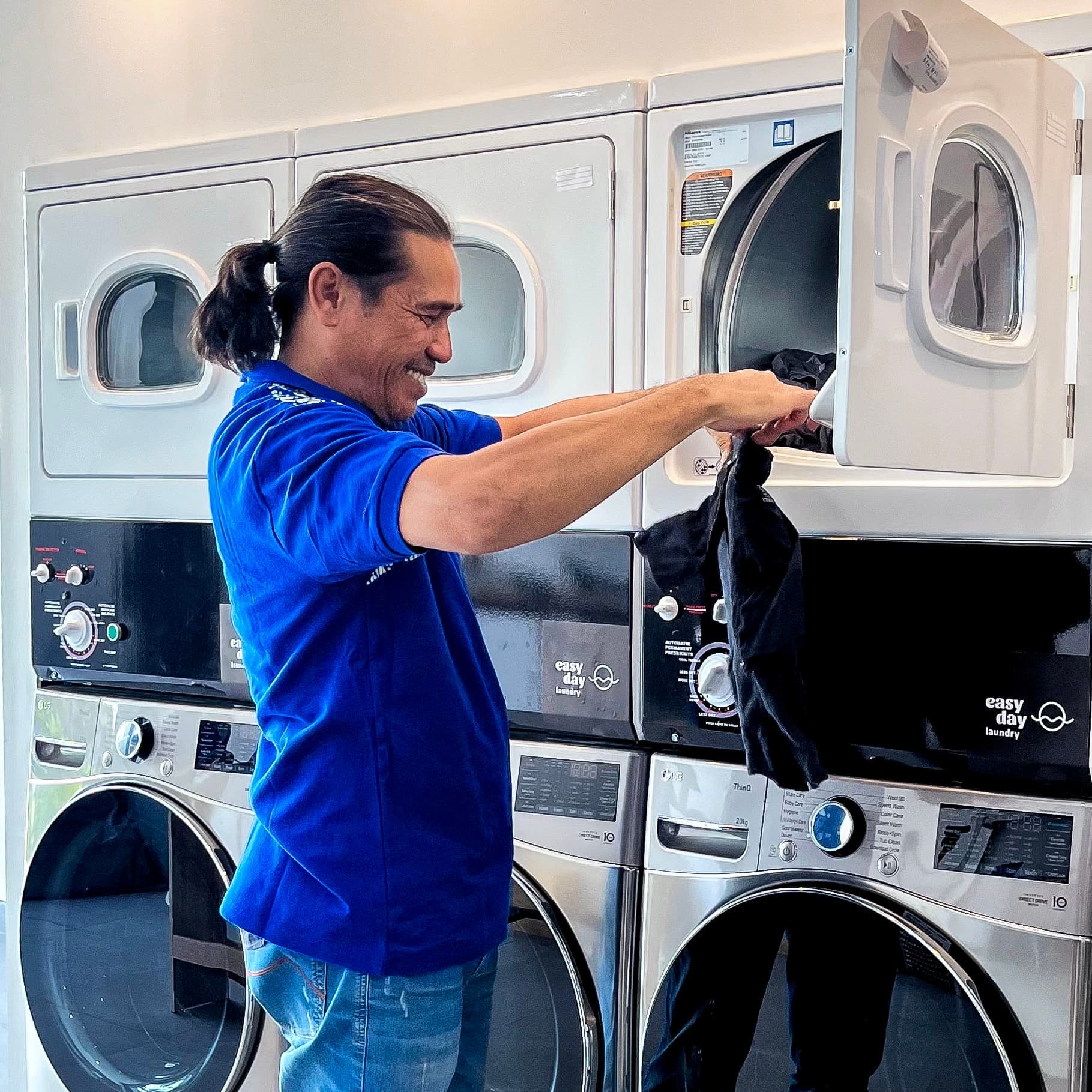 Easy Day team member loading the washing machines