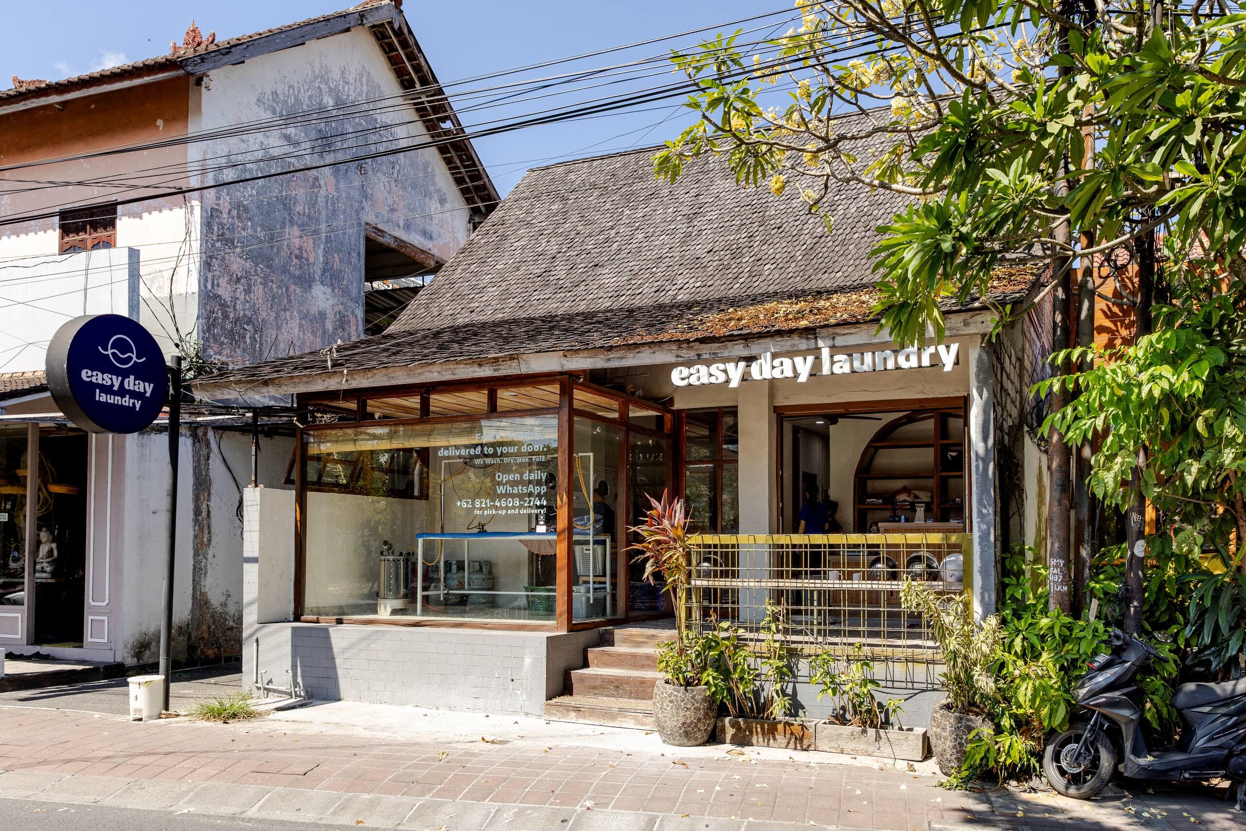 Easy Day Laundry Seminyak storefront on Jl. Mertanadi with traditional roof and signage