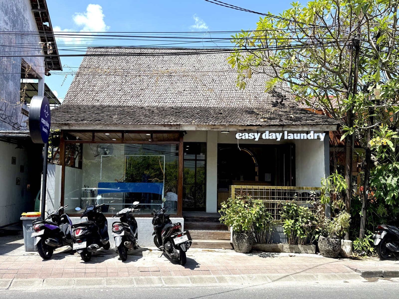 Easy Day Laundry Seminyak storefront on Jl. Mertanadi with traditional roof and signage