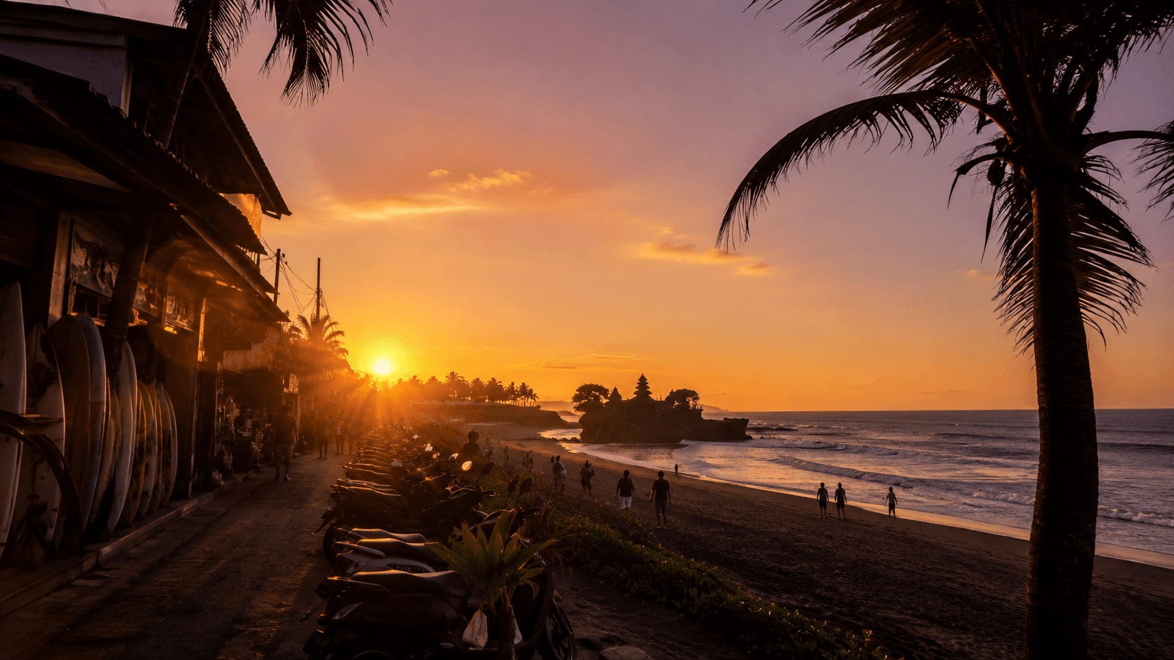 Batu Bolong Beach in Canggu at golden-hour sunset with surf shops, palm trees, and surfers walking on the sand