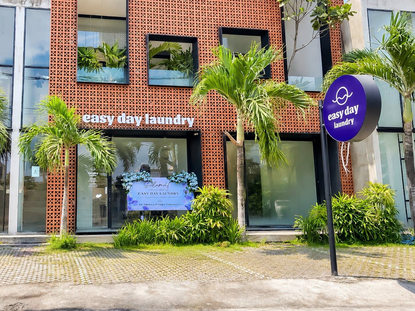 Easy Day Laundry Canggu storefront with brick facade and tropical palms
