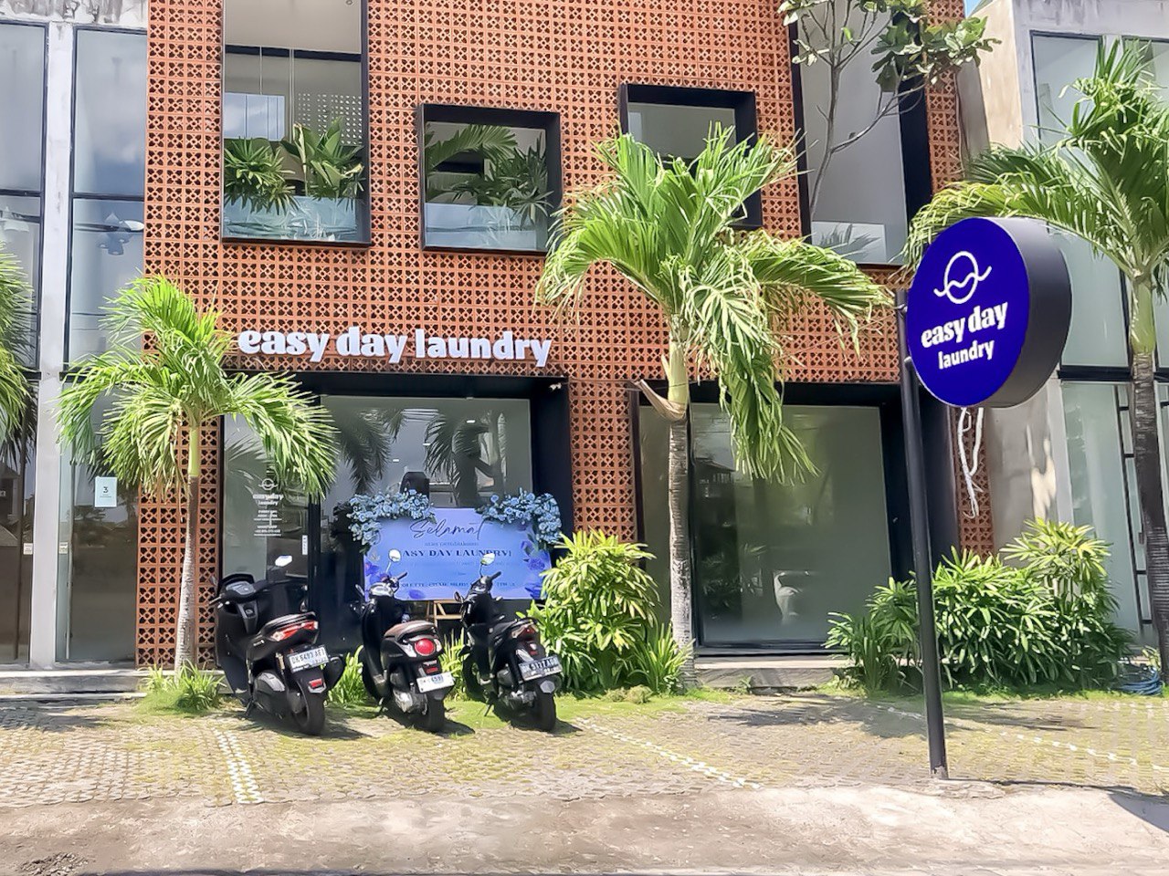 Easy Day Laundry Canggu storefront with signage and parked motorbikes in Canggu
